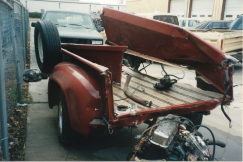 1967 Ford F-100 - This 1967 Ford F-100 shows its disassembled bed and spare tire, hinting at its current state in a wrecking yard.