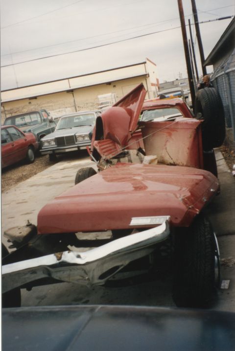1967 Ford F-100 - This heavily damaged 1967 Ford F-100 pickup truck sits in a junkyard with its front end severely compromised.