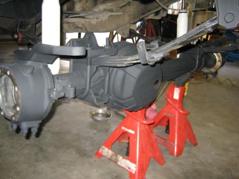 1987 Suzuki Samurai - Close-up of a vehicle's rear axle assembly, showing suspension components and differential housing.