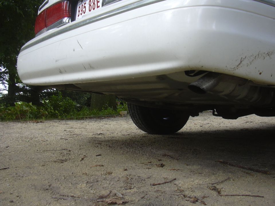 White 1997 Ford Crown Victoria rear bumper and exhaust pipe