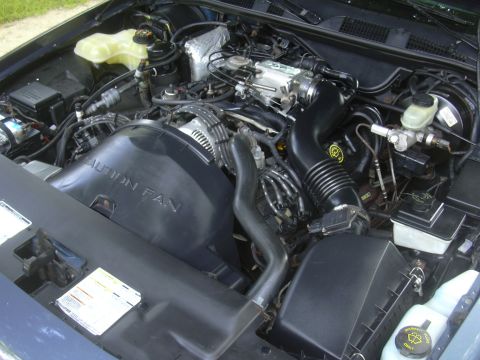 1997 Ford Crown Victoria - Engine bay detail showing the fan shroud with warning text.