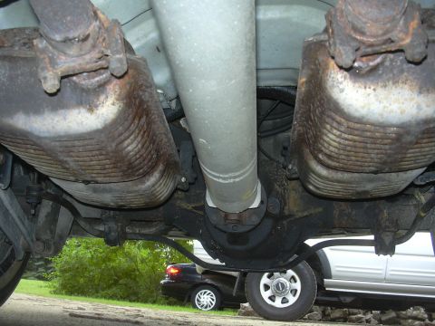 1997 Ford Crown Victoria - The undercarriage of a 1997 Ford Crown Victoria is visible, with a second vehicle in the background.