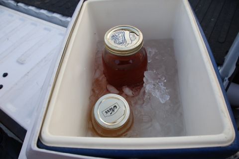 1996 Ford Bronco - Two jars of preserves are kept cool in a cooler filled with ice.
