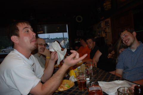 1996 Ford Bronco - A group of friends enjoys a meal together at a restaurant, with a vehicle visible outside.