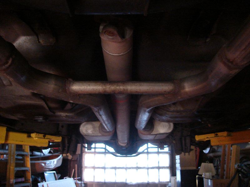 Undercarriage view of dual exhaust pipes and driveshaft