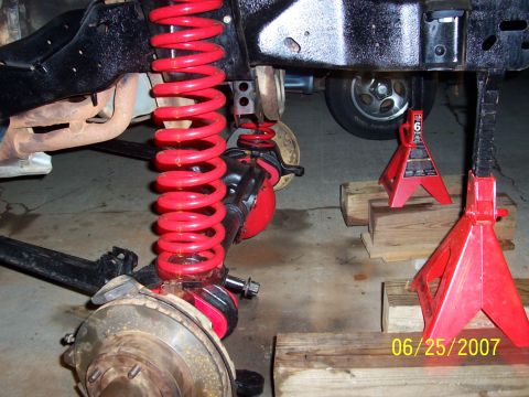1988 Ford Bronco - Close-up of red coil springs and suspension components supported by jack stands, with a date stamp of 06/25/2007.