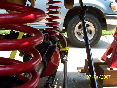 1988 Ford Bronco - Suspension work on a silver SUV, possibly a Ford Explorer, with a date stamp from 2007.