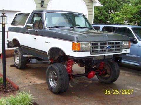 1988 Ford Bronco - This modified Ford Bronco features a significant lift and visible red suspension components, captured on June 25, 2007.