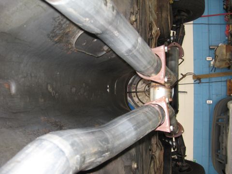 1973 Ford Ranchero - Underside view of a vehicle's drivetrain, focusing on the exhaust system and transmission connection.