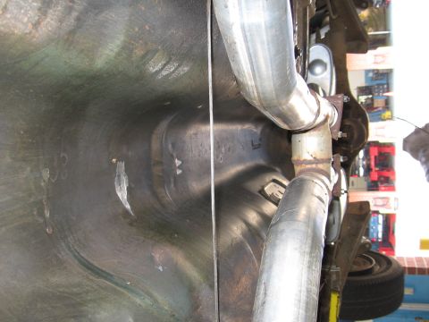 1973 Ford Ranchero - Underside view of a vehicle's exhaust system and fuel tank area.