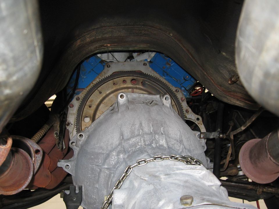 Transmission bell housing and flywheel with blue engine block visible