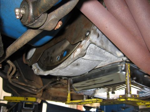 1973 Ford Ranchero - The underside of a vehicle is shown, focusing on the transmission and exhaust system components.