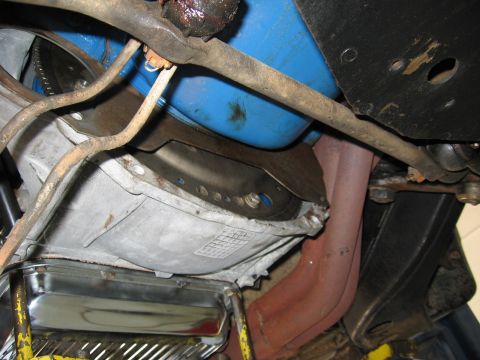 1973 Ford Ranchero - Close-up view of the engine and transmission components, showing the exhaust manifold and oil pan.