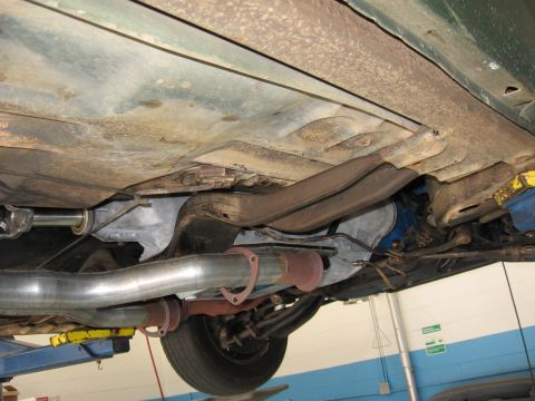 1973 Ford Ranchero - The underside of a 1973 Ford Ranchero, focusing on the transmission and exhaust components.