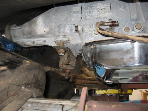 1973 Ford Ranchero - Underside view of a transmission and its chrome oil pan, showing the mounting bracket and rubber dampener.