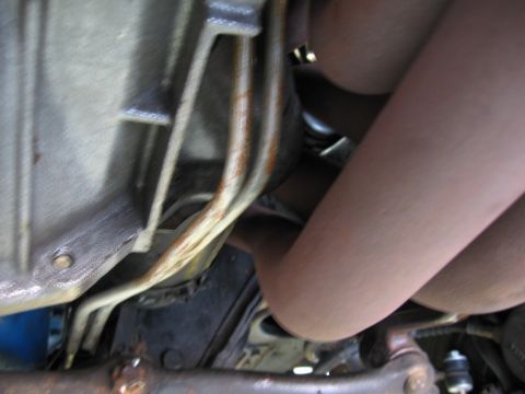 1973 Ford Ranchero - Close-up view of the vehicle's undercarriage, focusing on the transmission and exhaust system components.