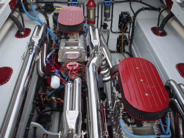 Twin supercharged V8 engine with chrome exhaust manifolds and red air cleaners