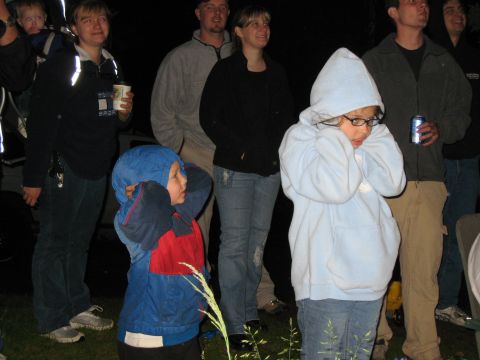 2000 Ford E350 - People gathered outdoors at night, some children covering their ears.