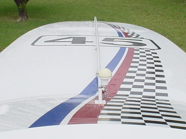 Top of a boat with racing stripes and numbers 45. Has a small antenna
