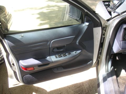1997 Ford Crown Victoria - Close-up of a car's interior door panel, showing the window and lock controls.