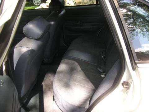 1997 Ford Crown Victoria - The interior of a car is shown, focusing on the rear seating area and door panel.