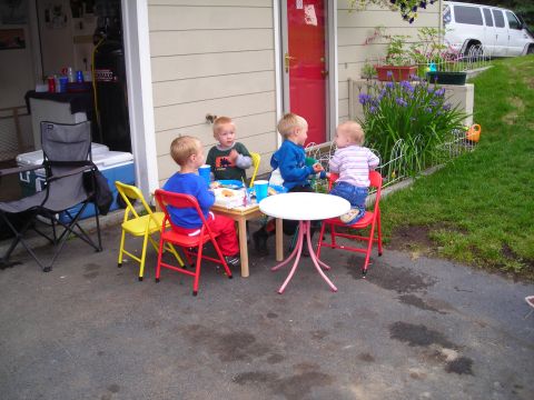 2003 Jeep TJ - Children enjoy snacks and drinks at a table set up in front of a garage.