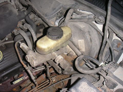 1997 Ford Crown Victoria - Close-up of the brake master cylinder and booster assembly in the engine bay.