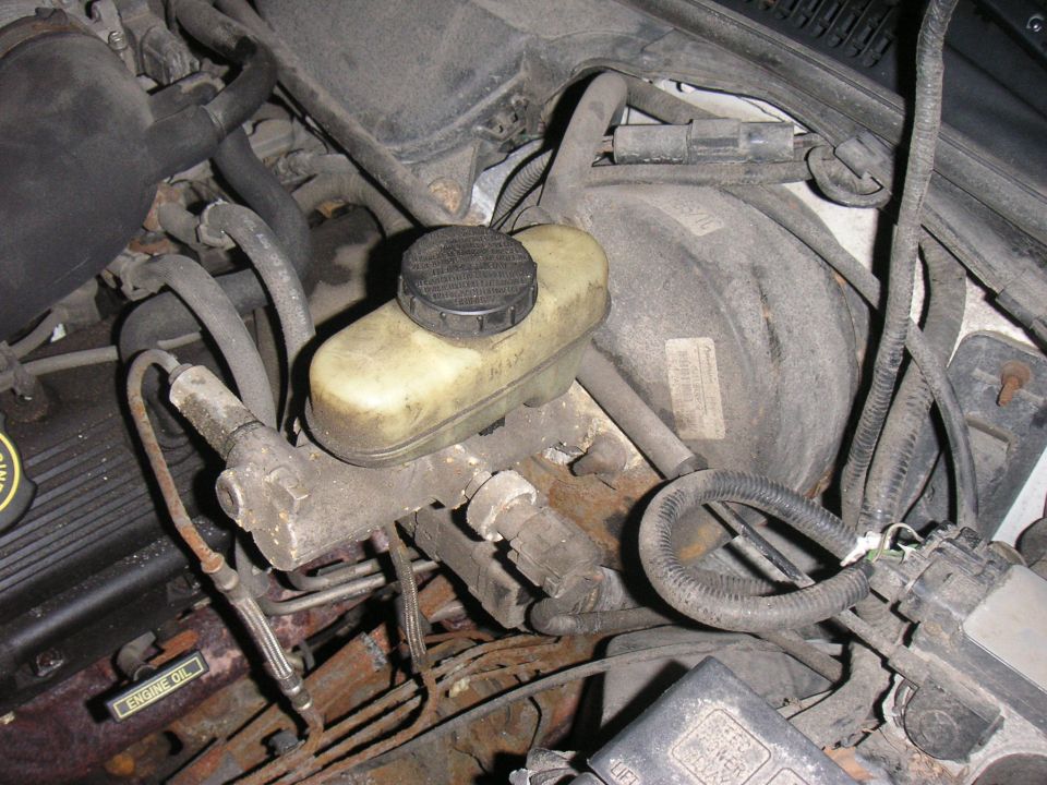1997 Ford Crown Victoria engine bay shows brake master cylinder and booster