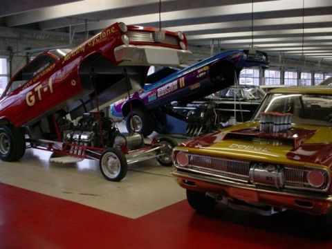 1972 Ford Ranchero - A collection of drag racing vehicles, including a yellow and red Dodge in the foreground and a red Mercury Cyclone dragster.