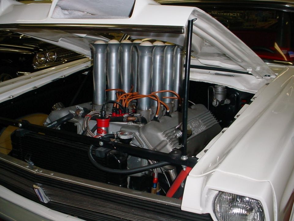 White 1972 Ford Ranchero engine with chrome stacks and scoop