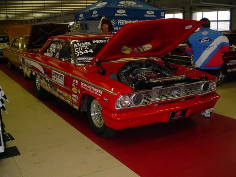 1972 Ford Ranchero - A red 1964 Ford Galaxie drag car is displayed with its hood open, revealing the engine and intake system.
