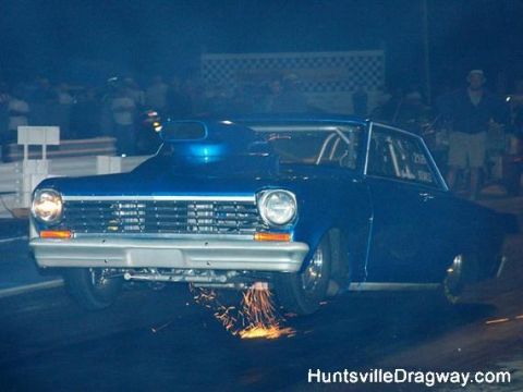 1972 Ford Ranchero - A blue drag car launches off the starting line, kicking up a shower of sparks.