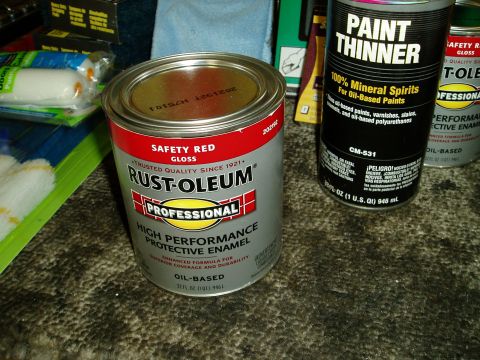 2000 Ford E350 - Various painting supplies including cans of Rust-Oleum and paint thinner, along with rollers.