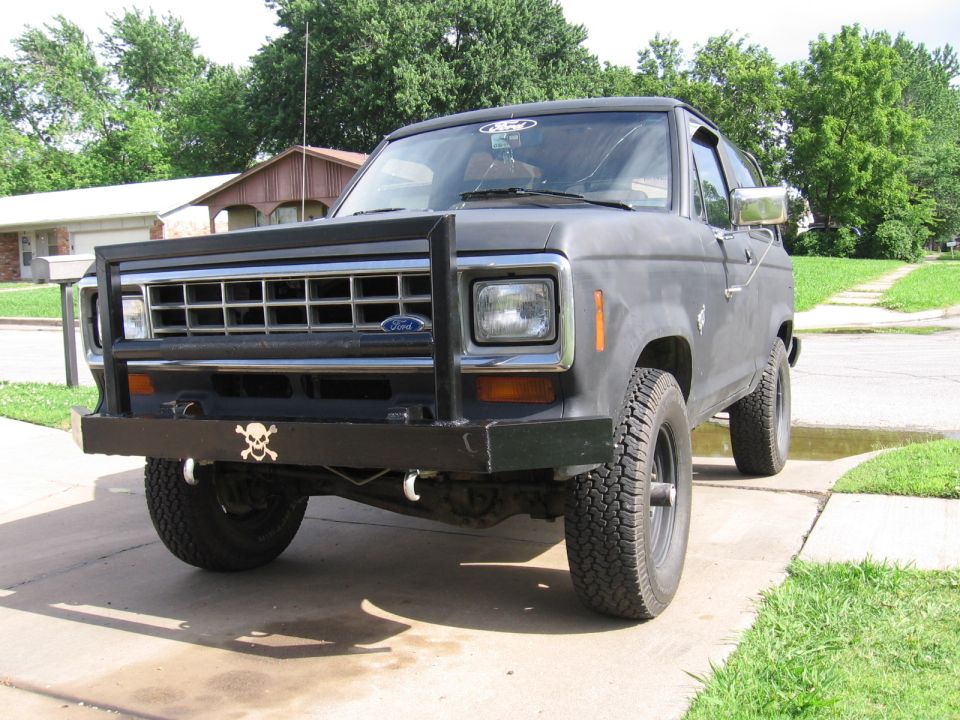 Front view of a gray 1984 Ford Bronco II with a bull bar and skull decal on the bumper