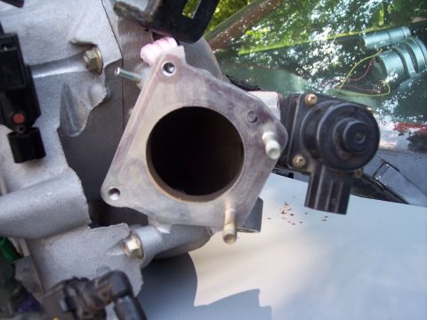 1994 Ford Probe - Close-up of an automotive intake manifold part, likely for a Mazda Protege.
