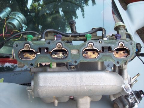 1994 Ford Probe - This is a close-up view of a vehicle's intake manifold, showing the fuel injectors and throttle bodies.