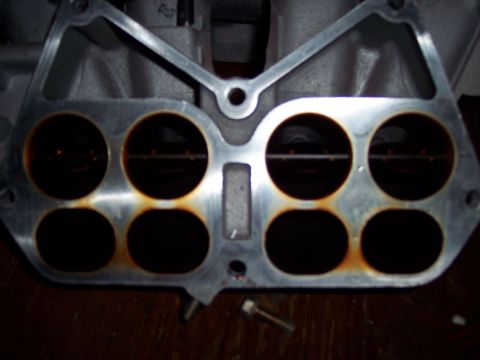 1994 Ford Probe - Engine intake manifold part with eight ports, showing signs of rust.