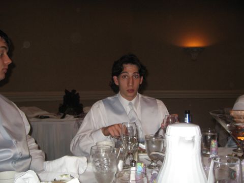1988 Ford Bronco - A man in formal attire sits at a table during a wedding reception, looking surprised.