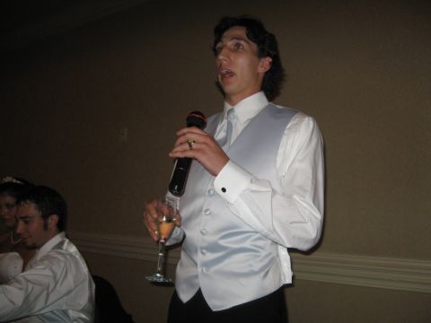 1988 Ford Bronco - A man addresses a wedding reception crowd while holding a microphone and a champagne flute.