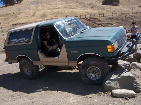 1991 Ford Bronco - 1991 Ford Bronco navigating rocky terrain with doors removed.