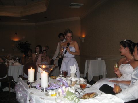 1988 Ford Bronco - A wedding reception is underway with guests seated at tables and a woman giving a speech.