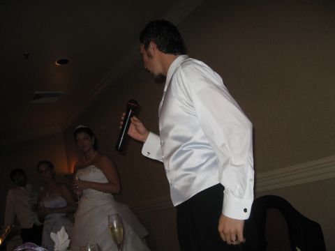 1988 Ford Bronco - A man gives a toast at a wedding reception while the bride and other guests look on.