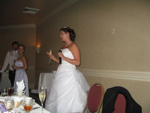 1988 Ford Bronco - Bride speaks at her wedding reception, holding a microphone and a glass of champagne.