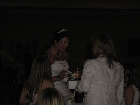 1988 Ford Bronco - A bride wearing a tiara and necklace interacts with guests during a wedding reception.