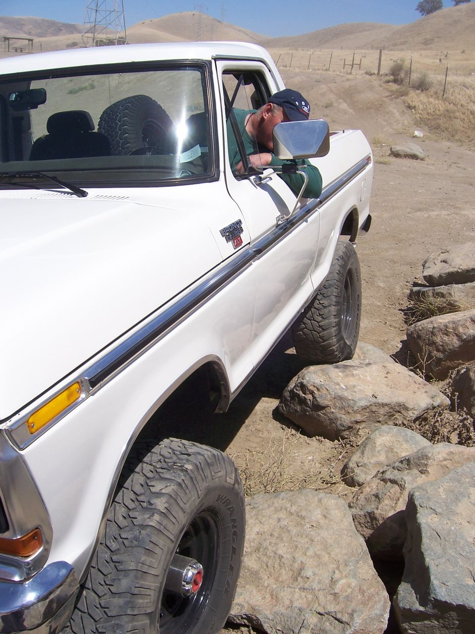 White Ford F-Series truck navigating rocks