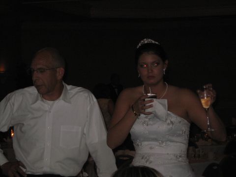 1988 Ford Bronco - Man and woman at a wedding reception, both holding drinks.