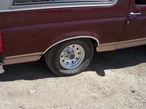 1991 Ford Bronco - Close-up of the rear wheel and fender of a 1991 Ford Bronco.