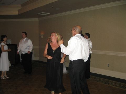 1988 Ford Bronco - Guests dance at a wedding reception, with a watermark for SUPERMOTORS.net visible.
