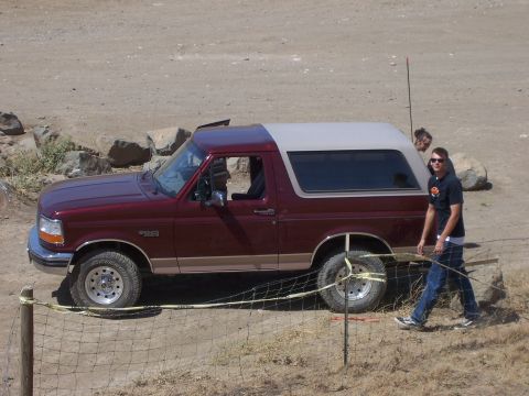 1991 Ford Bronco - A maroon SUV with a tan top is parked outdoors. The vehicle appears to be a 1992 Ford Bronco.