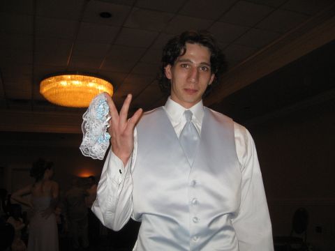 1988 Ford Bronco - Man holds a garter at what appears to be a wedding reception.